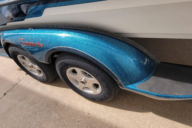 Slide: The Image of 2000 Ranger 522DVX Comanche boat trailer with blue metallic finish and dual wheels. - 5