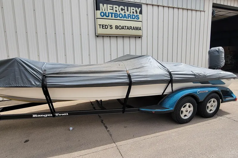 Slide: The Image of Covered 2000 Ranger 522DVX Comanche boat on trailer outside Mercury Outboards shop. - 8