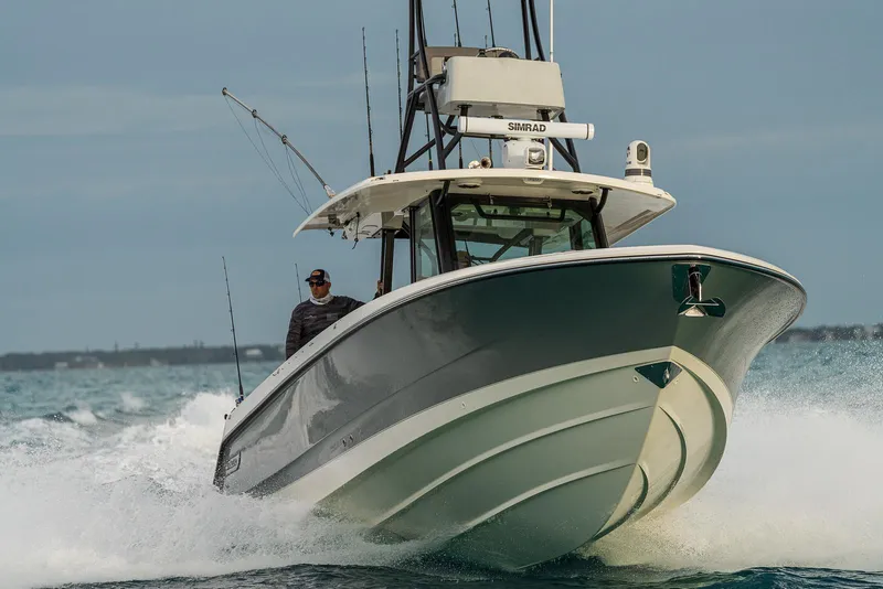 Slide: The Image of Manufacturer Provided Image: 2026 Boston Whaler 360 Outrage cruising on open water, showcasing sleek design and power. - 3