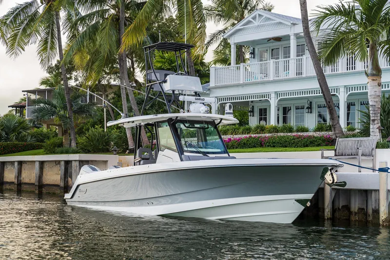 Slide: The Image of Manufacturer Provided Image: 2026 Boston Whaler 360 Outrage docked by a waterfront home with palm trees. - 5