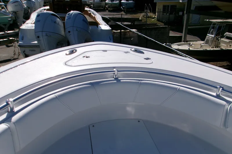 Slide: The Image of 2026 Sportsman Open 232 Center Console boat with dual engines, docked in a marina. - 11