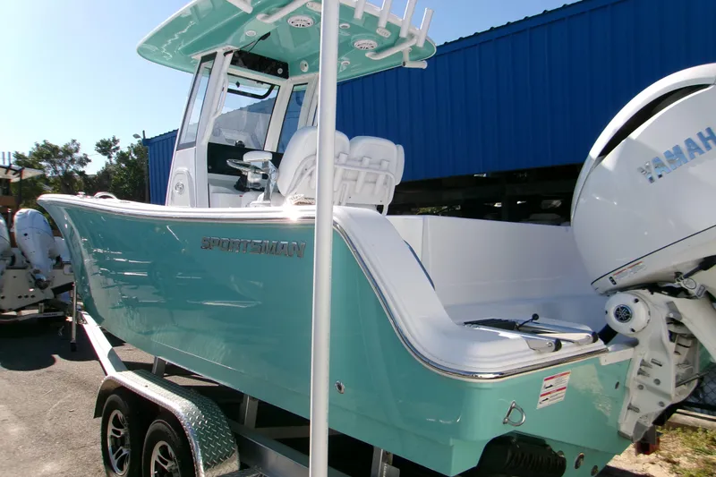 Slide: The Image of 2026 Sportsman Open 232 Center Console boat with Yamaha engine on trailer. - 2