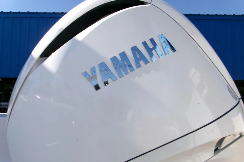 Slide: The Image of Yamaha engine on 2026 Sportsman Open 232 Center Console boat, blue building background. - 3