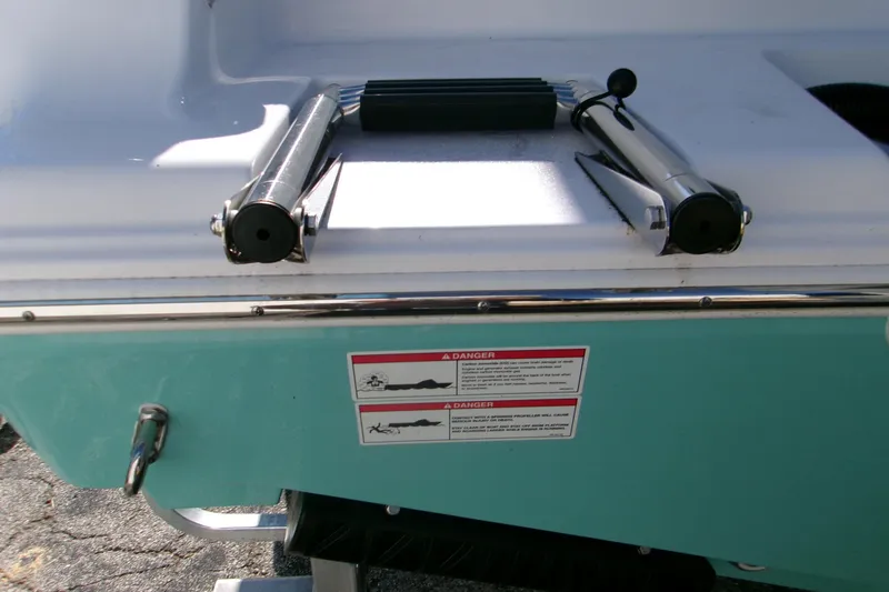 Slide: The Image of 2026 Sportsman Open 232 Center Console boat with folded ladder and safety warning labels. - 5