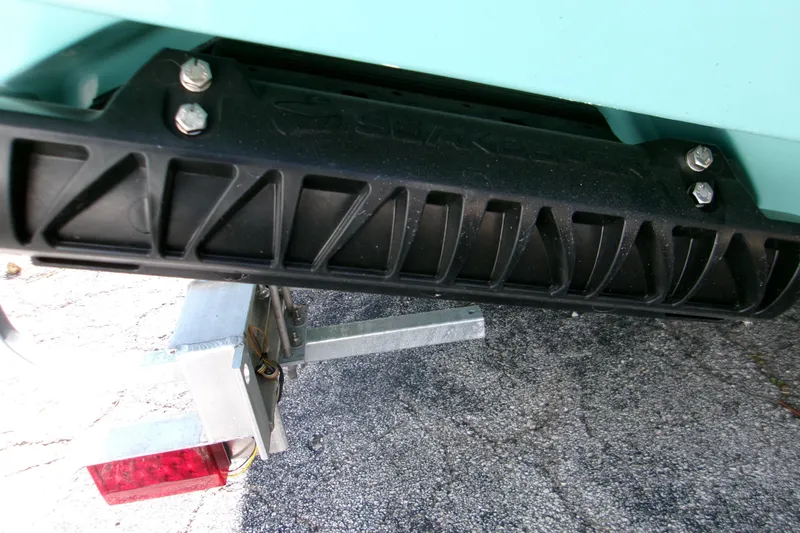 Slide: The Image of 2026 Sportsman Open 232 Center Console boat trailer detail with black bumper. - 6