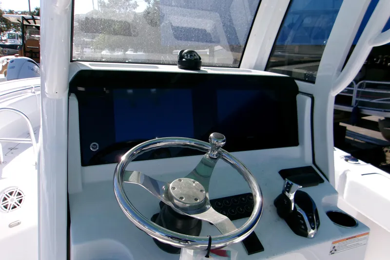 Slide: The Image of 2026 Sportsman Open 232 Center Console boat dashboard with steering wheel and controls. - 8