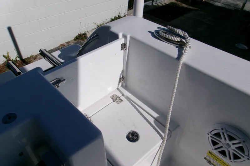 Slide: The Image of 2026 Sportsman Open 232 Center Console boat interior with rope and speaker detail. - 9