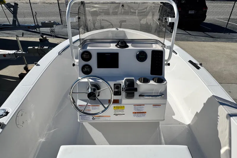 Slide: The Image of 2026 Robalo R160 Center Console boat interior with steering wheel and controls. - 3