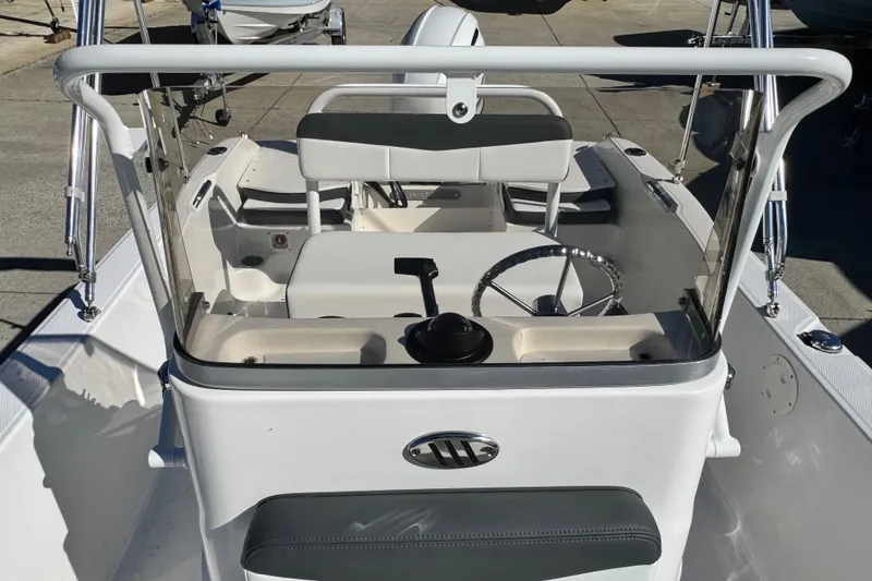 Slide: The Image of 2026 Robalo R160 Center Console boat interior with steering wheel and seating. - 4