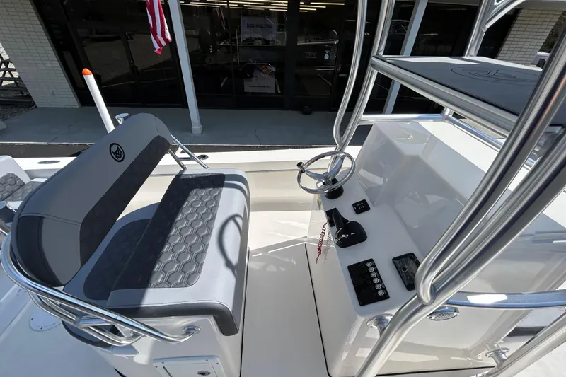 Slide: The Image of 2026 May-Craft 238 Offshore CC boat interior with steering console and seating. - 12