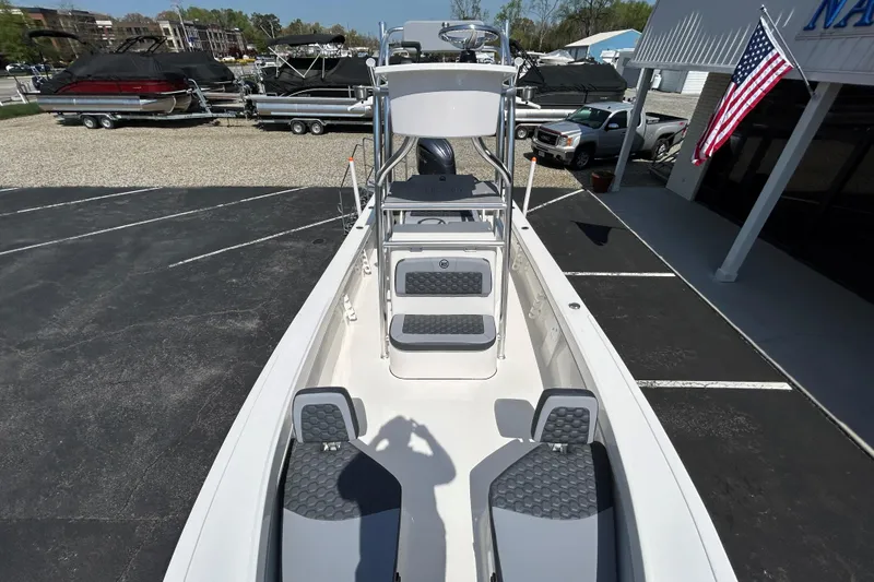 Slide: The Image of 2026 May-Craft 238 Offshore CC boat displayed at a dealership with American flag. - 16