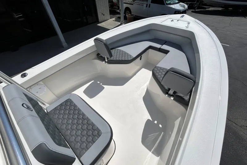 Slide: The Image of 2026 May-Craft 238 OFFSHORE CC boat interior with cushioned seating and spacious deck. - 19