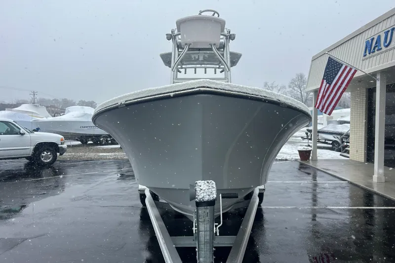 Slide: The Image of 2026 May-Craft 238 Offshore CC boat in snowy dealership lot, American flag visible. - 2