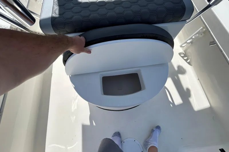 Slide: The Image of 2026 May-Craft 238 Offshore CC boat seat with storage compartment open. - 20