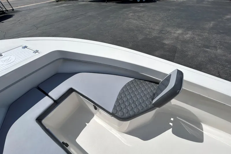 Slide: The Image of 2026 May-Craft 238 OFFSHORE CC boat interior with cushioned seating and storage compartment. - 23