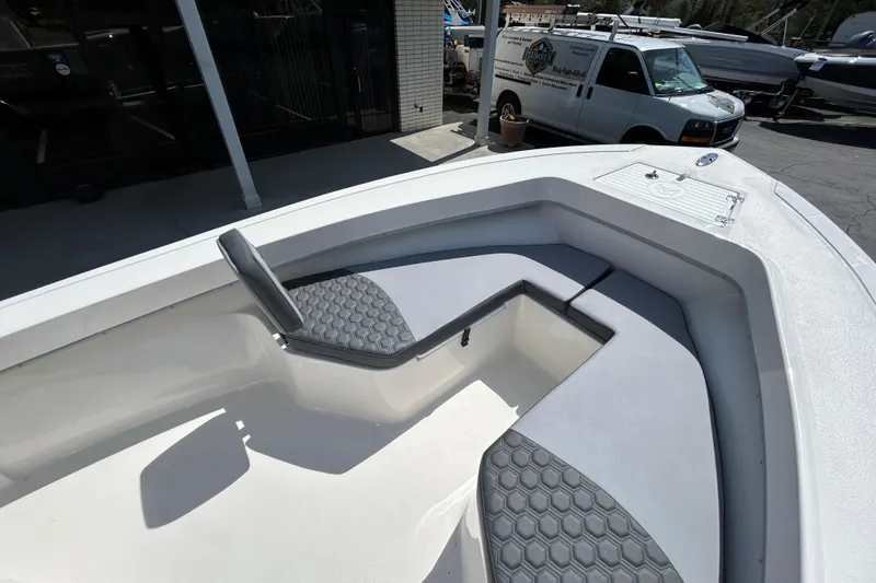 Slide: The Image of 2026 May-Craft 238 Offshore CC boat with cushioned seating and storage compartments. - 24