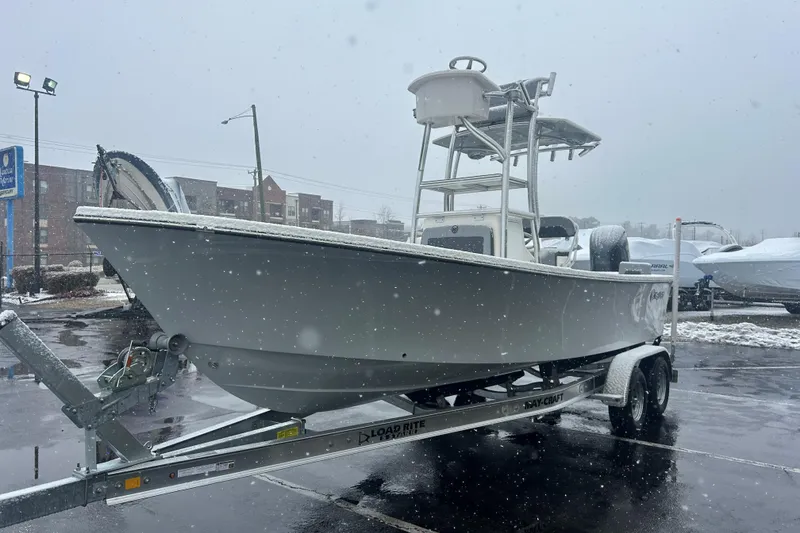 Slide: The Image of 2026 May-Craft 238 Offshore CC boat on trailer in snowy parking lot. - 3