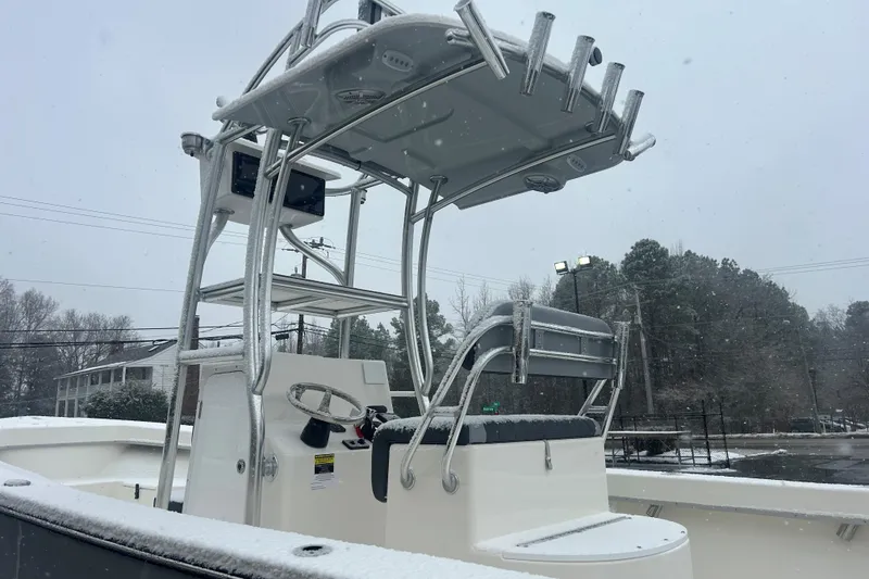 Slide: The Image of 2026 May-Craft 238 Offshore CC boat in snowy weather, showcasing helm and seating area. - 6