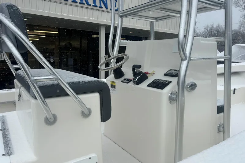 Slide: The Image of 2026 May-Craft 238 Offshore CC boat console with snow-covered seating and controls. - 8