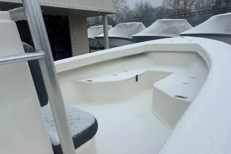 Slide: The Image of 2026 May-Craft 238 Offshore CC boat covered in snow, docked outdoors. - 9