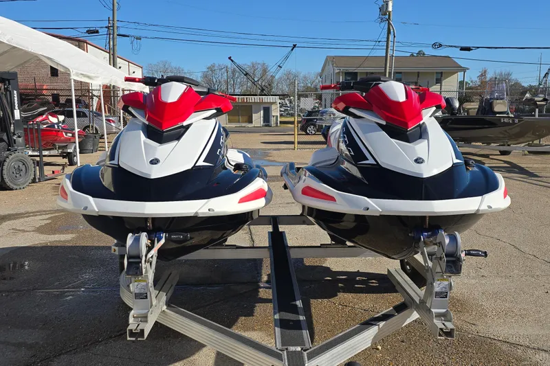 Slide: The Image of Two 2021 Yamaha WaveRunner VX Deluxe jet skis on a trailer in a parking lot. - 1