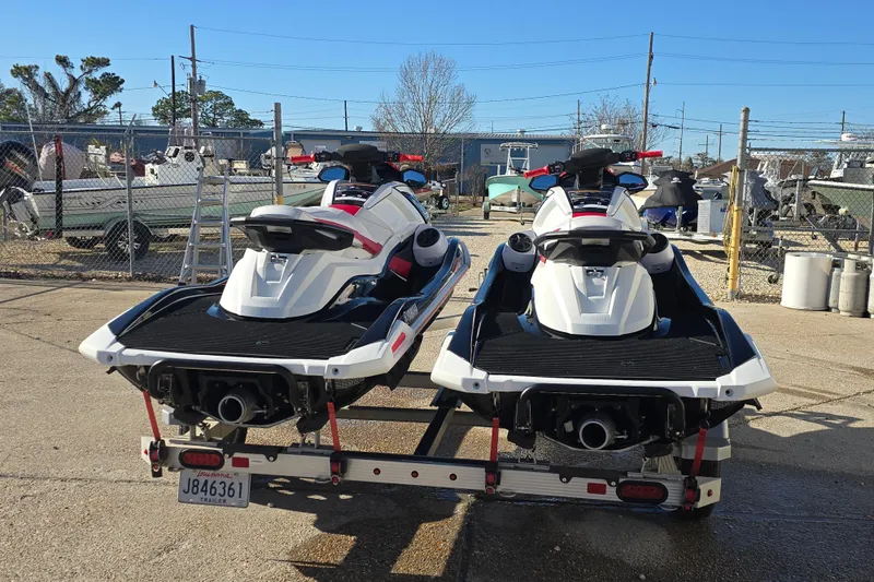 Slide: The Image of Two 2021 Yamaha WaveRunner VX Deluxe jet skis on a trailer in a marina. - 4