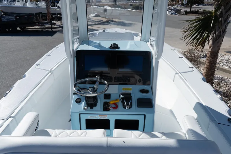 Slide: The Image of 2026 Blazer Bay Makaira 2600 boat cockpit with steering wheel and control panel. - 11