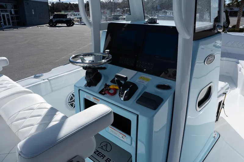 Slide: The Image of 2026 Blazer Bay Makaira 2600 boat cockpit with steering wheel and control panel. - 13