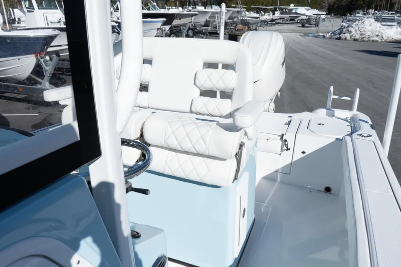 Slide: The Image of 2026 Blazer Bay Makaira 2600 boat interior with white seating and steering wheel. - 15