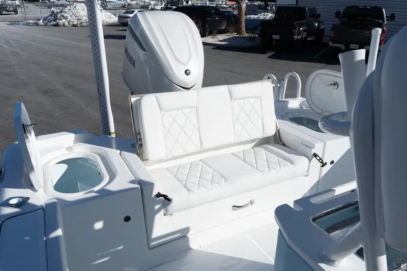 Slide: The Image of 2026 Blazer Bay Makaira 2600 boat interior with white seating and storage compartments. - 9