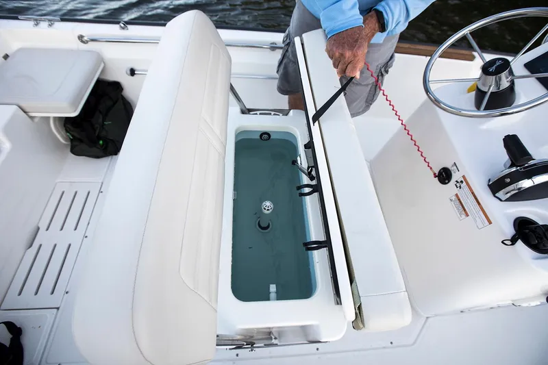 Slide: The Image of Manufacturer Provided Image: 2026 Boston Whaler 170 Montauk boat interior with open storage compartment and steering console. - 26