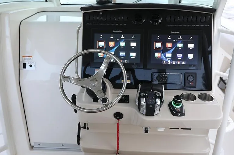 Slide: The Image of Manufacturer Provided Image: 2025 Boston Whaler 380 Outrage helm with dual touchscreen displays and modern controls. - 11