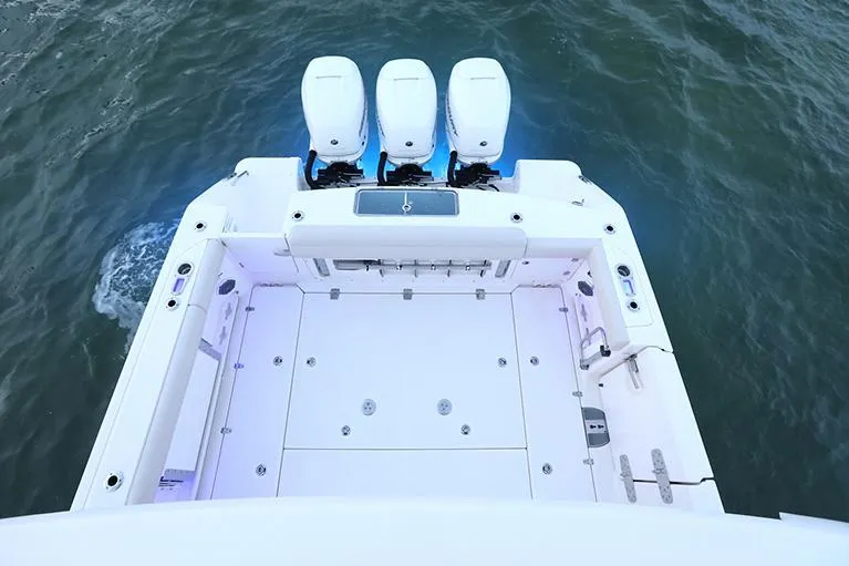 Slide: The Image of Manufacturer Provided Image: Boston Whaler 380 Outrage 2025 boat deck with triple engines on water. - 6