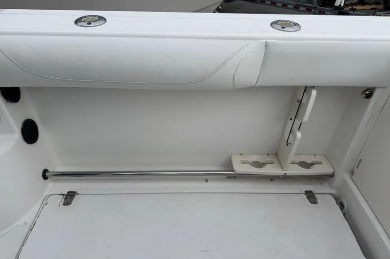 Slide: The Image of 2005 Boston Whaler 255 Conquest interior detail with rod holder and storage compartment. - 11