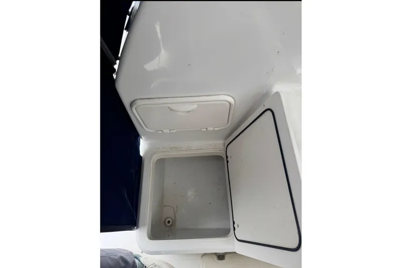 Slide: The Image of Open storage compartment on a 2005 Boston Whaler 255 Conquest boat. - 19