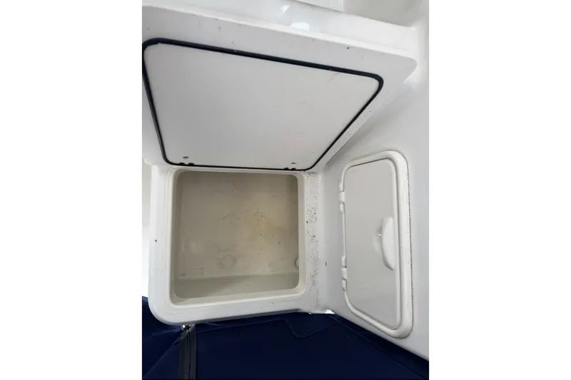 Slide: The Image of Open storage compartment on a 2005 Boston Whaler 255 Conquest boat. - 20
