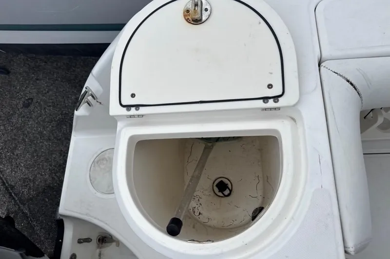 Slide: The Image of Open storage compartment on a 2005 Boston Whaler 255 Conquest boat. - 22