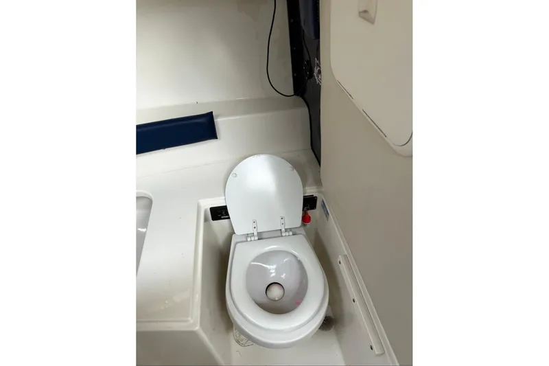 Slide: The Image of 2005 Boston Whaler 255 Conquest boat interior with toilet. - 25