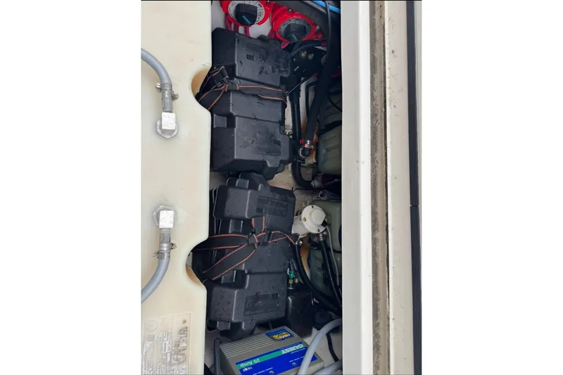 Slide: The Image of Engine compartment of a 2005 Boston Whaler 255 Conquest with visible battery setup. - 26