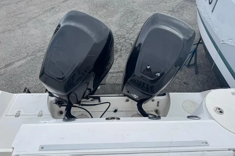 Slide: The Image of Twin outboard motors on a 2005 Boston Whaler 255 Conquest boat. - 30