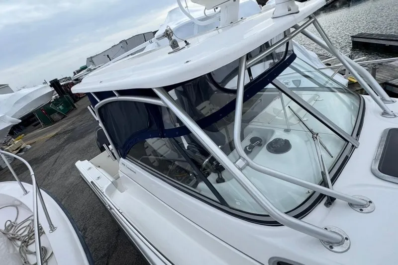 Slide: The Image of 2005 Boston Whaler 255 Conquest boat docked, showcasing sleek design and sturdy construction. - 5