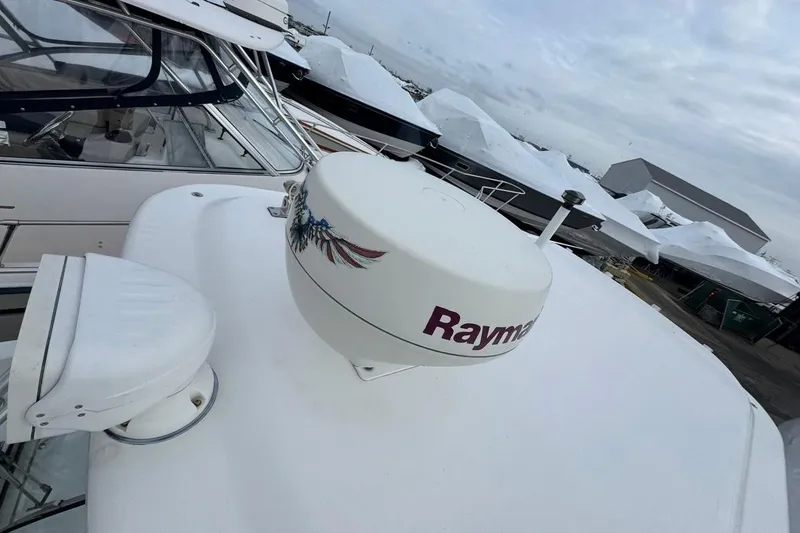 Slide: The Image of 2005 Boston Whaler 255 Conquest with Raymarine radar, docked with other boats. - 8