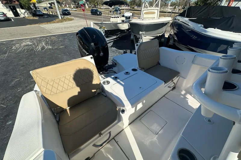 Slide: The Image of 2021 Bayliner Trophy T22CC boat interior with seating and engine view. - 10