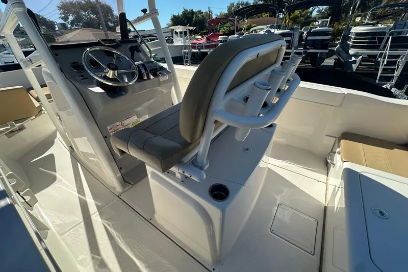 Slide: The Image of 2021 Bayliner Trophy T22CC boat interior with steering console and seating. - 12