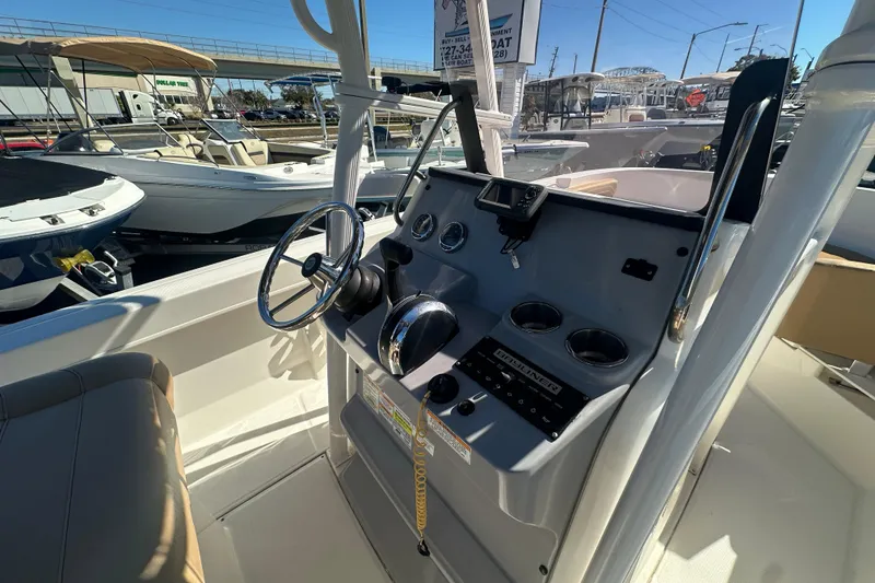 Slide: The Image of 2021 Bayliner Trophy T22CC boat console with steering wheel and controls. - 15