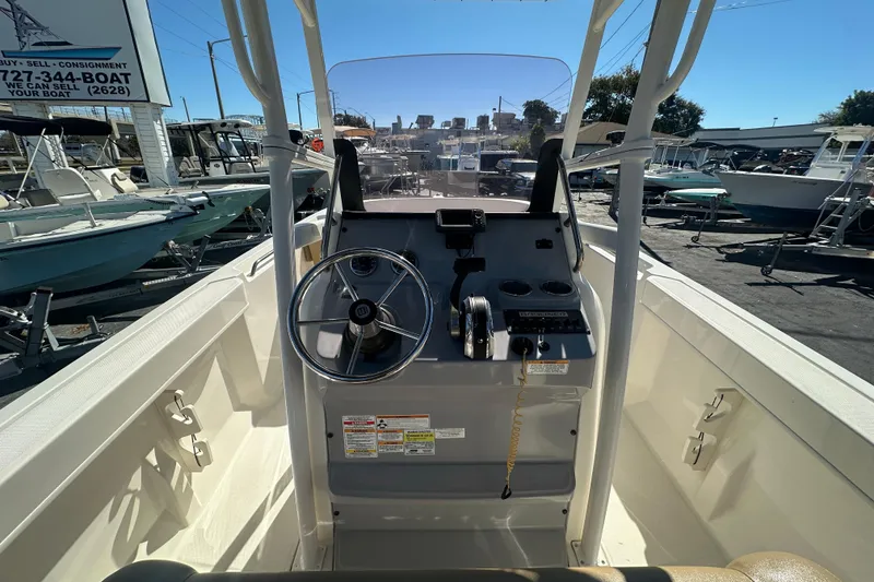 Slide: The Image of 2021 Bayliner Trophy T22CC boat console with steering wheel and controls. - 16