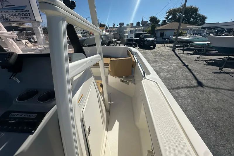 Slide: The Image of 2021 Bayliner Trophy T22CC boat interior with seating, docked outdoors under sunlight. - 19