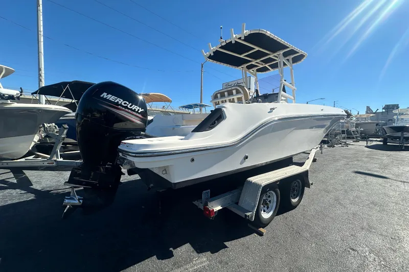 Slide: The Image of 2021 Bayliner Trophy T22CC boat on trailer with Mercury outboard engine. - 2
