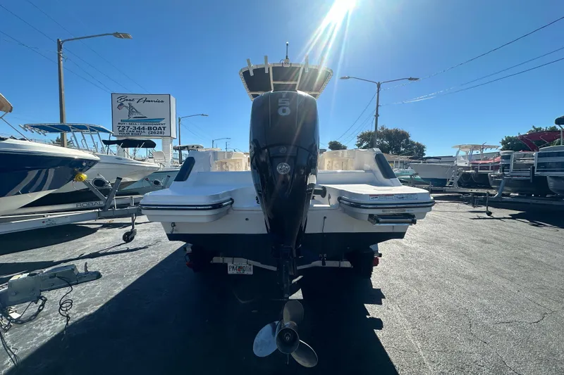 Slide: The Image of 2021 Bayliner Trophy T22CC boat with outboard motor in a sunny dealership lot. - 3