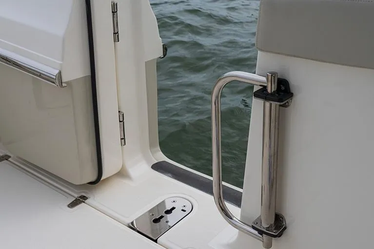 Slide: The Image of Manufacturer Provided Image: 2026 Boston Whaler 280 Vantage boat door with stainless steel handle, open to water view. - 7